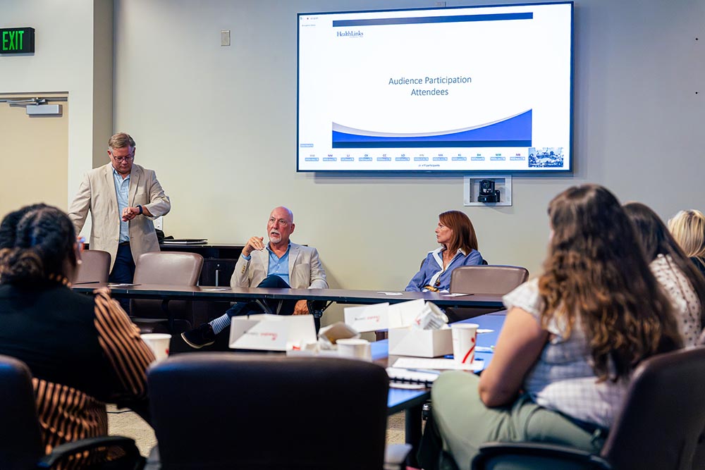Attendees seated around the conference table during the presentation.